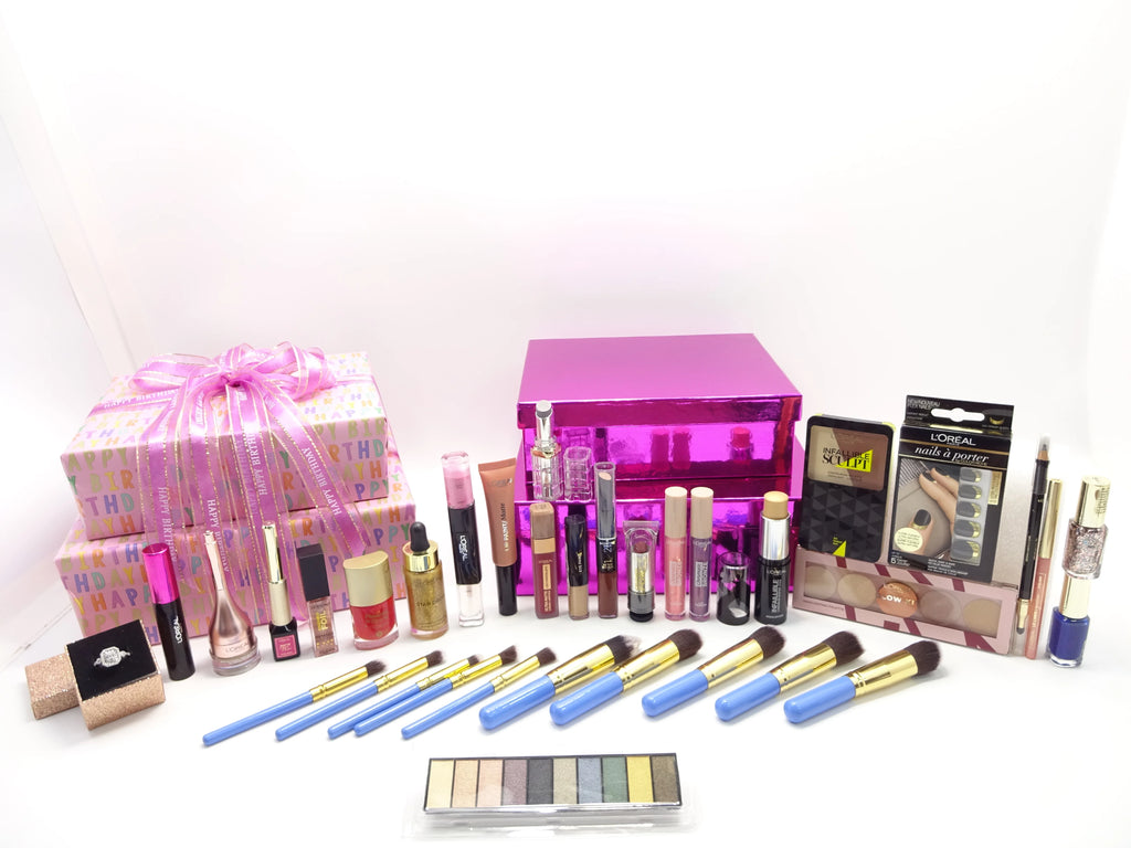 Assorted makeup products including lipsticks, brushes, and a pink makeup organizer on a white background.