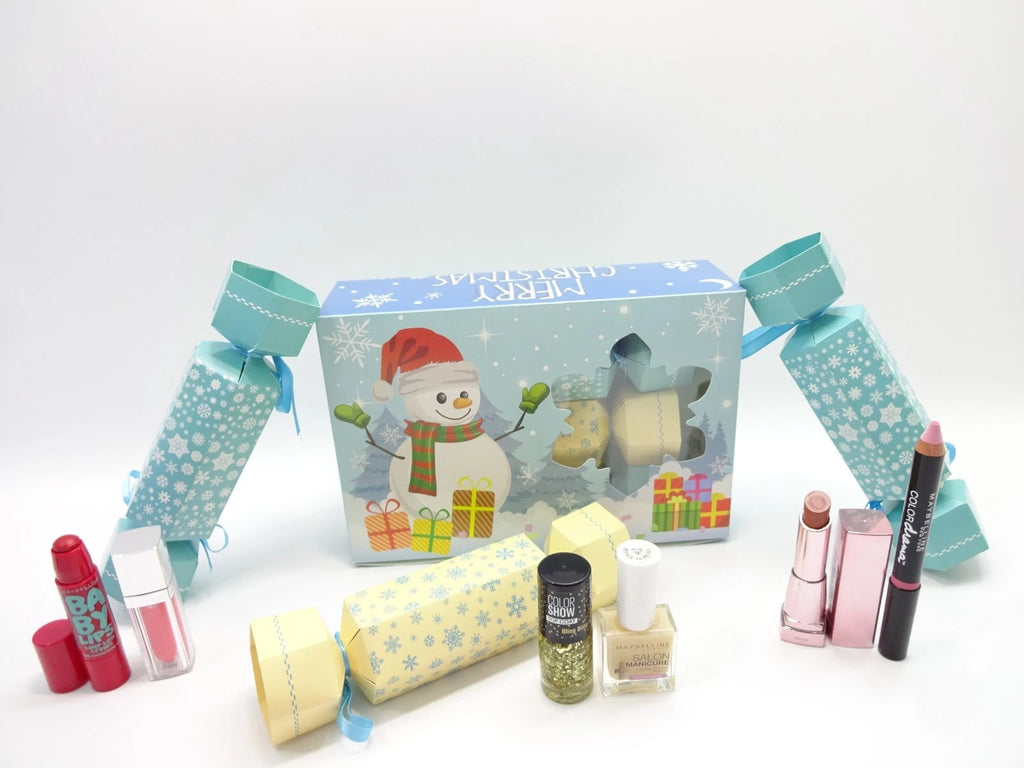 Maybelline Christmas Cracker Collection featuring snowman-themed box and pastel blue and yellow crackers