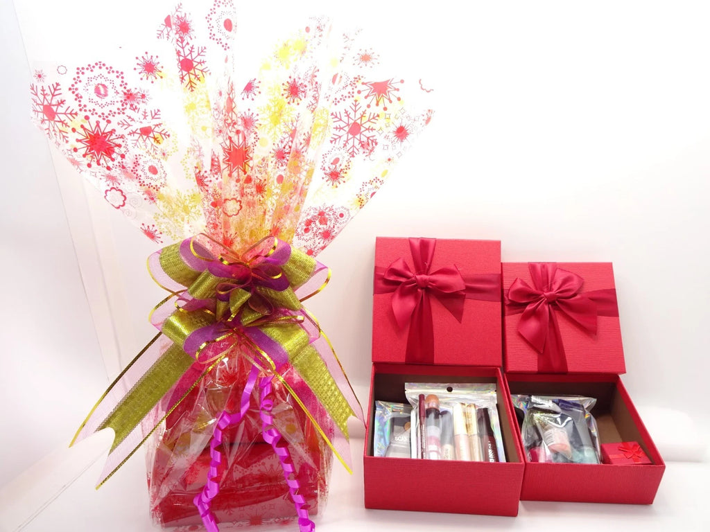 Bouquet of flowers with decorative elements next to a red gift box on a white background
