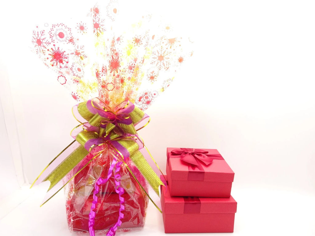 Gift box with colorful ribbons and a bouquet of flowers on a white background