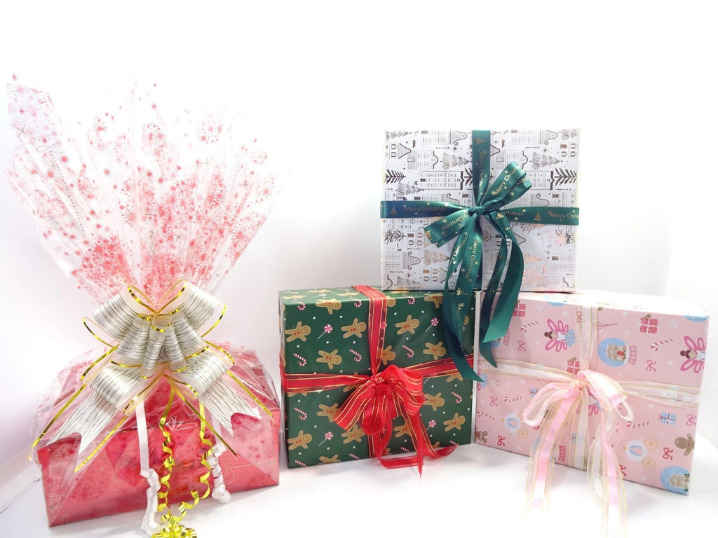 Four gift boxes with colorful ribbons on a white background