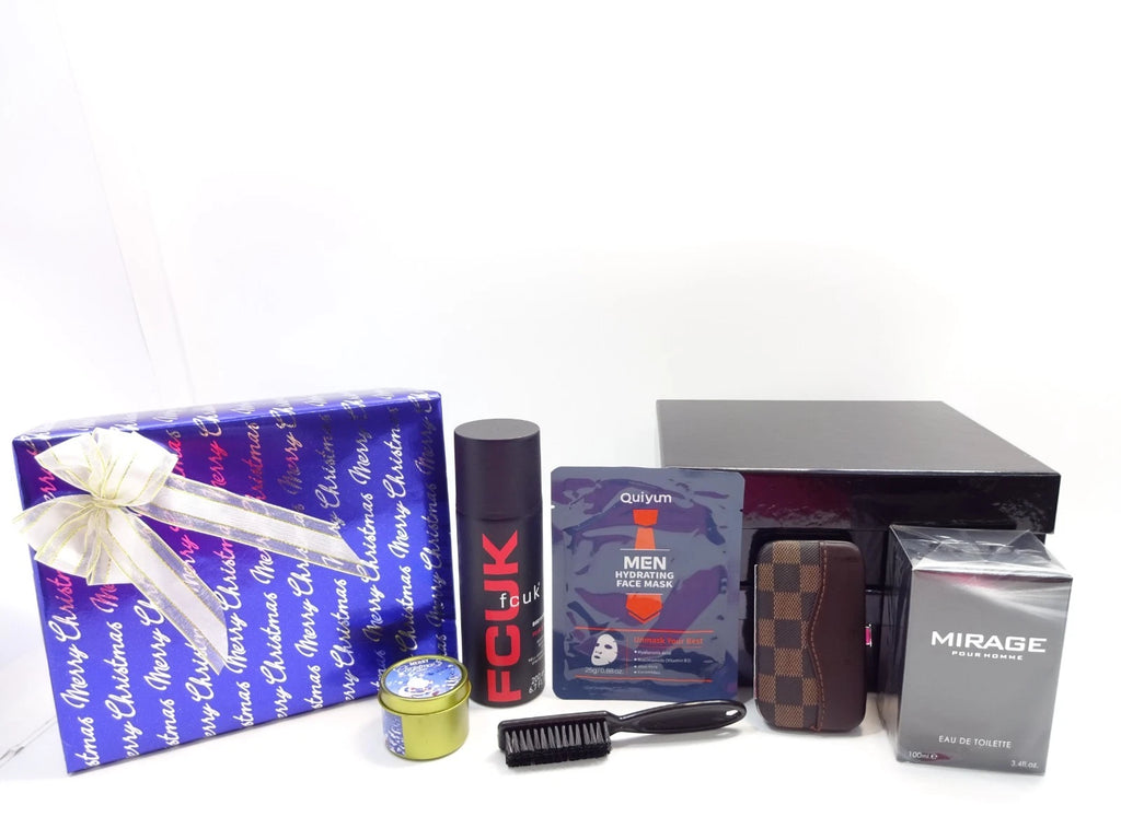 Luxury men’s Christmas gift set including perfume, deodorant, face mask, grooming kit, and candle displayed beside gift-wrapped box and black presentation box.