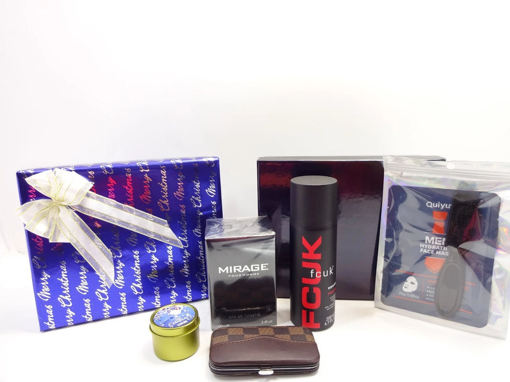 Arrangement of men’s Christmas gift set including perfume, face mask, candle, and grooming kit with black and blue boxes in the background.