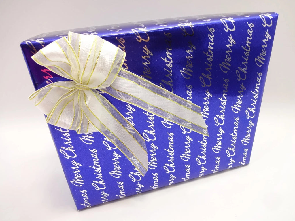 Complete display of men’s grooming and fragrance Christmas set including perfume, FCUK deodorant, face mask, grooming kit, and candle in front of gift boxes.