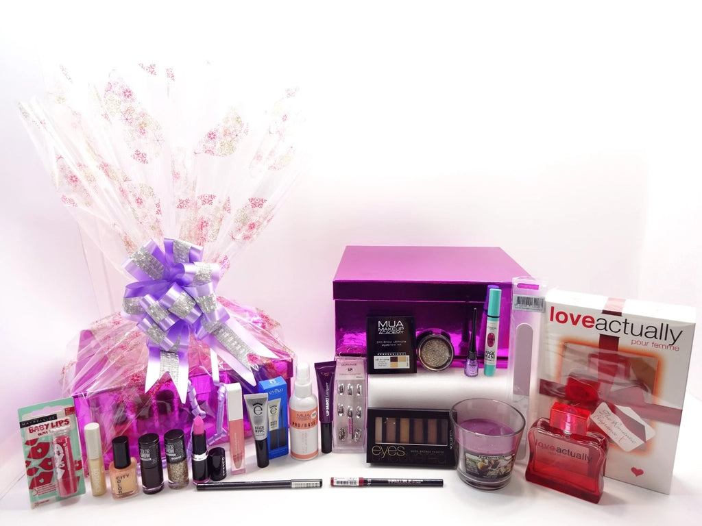 Luxury Christmas 2025 beauty and fragrance hamper wrapped in festive cellophane with elegant purple and silver bow