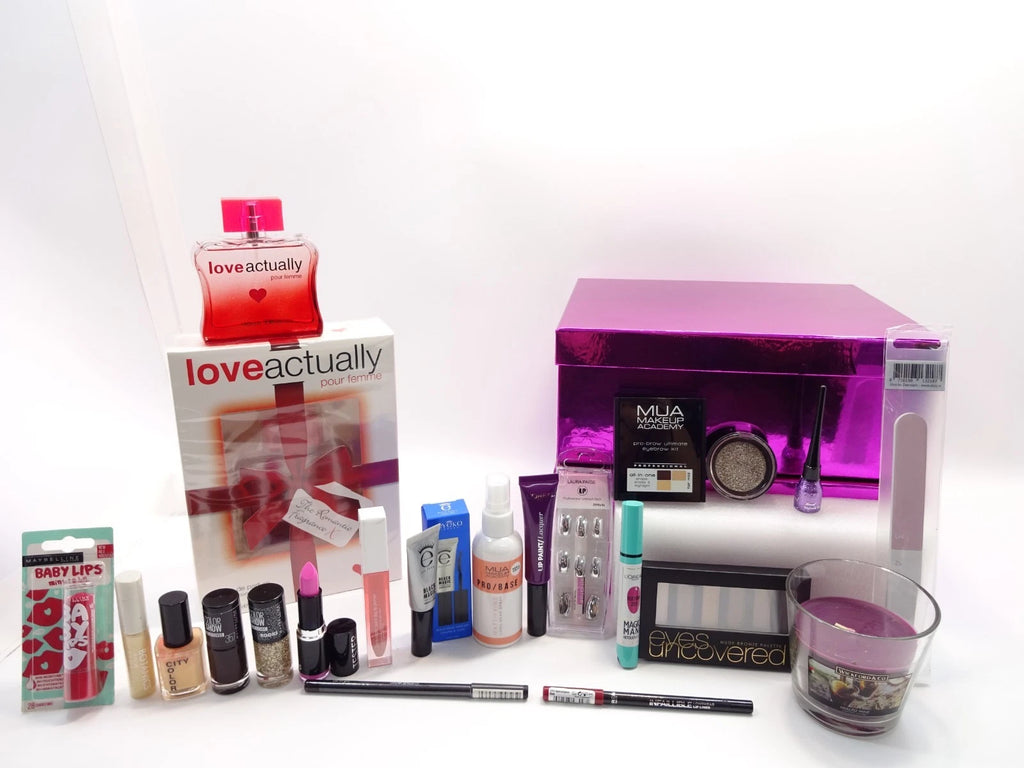 Open view of luxury pink gift box with beauty and fragrance products arranged beside it