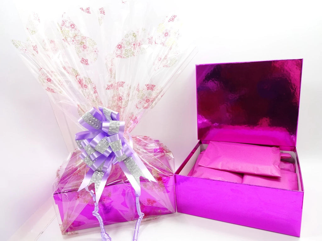 Pink luxury gift box with beauty products neatly tissue wrapped inside