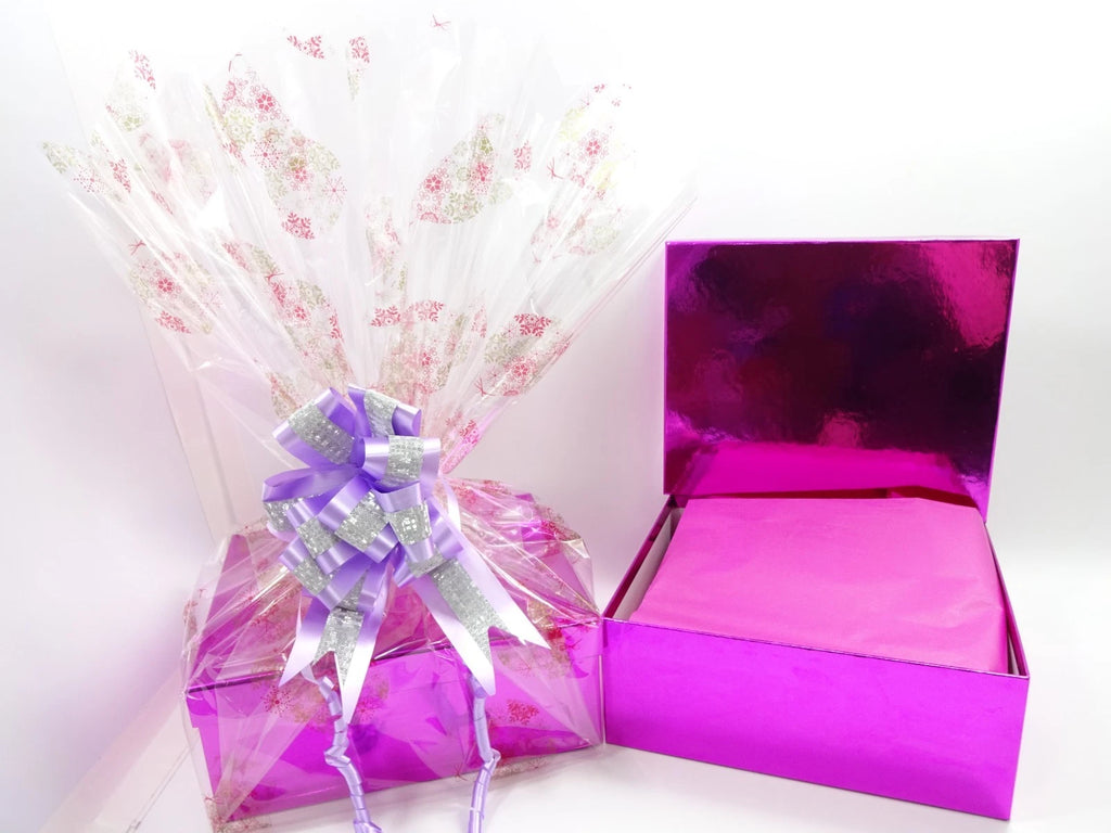Open pink luxury box showing tissue-wrapped contents inside