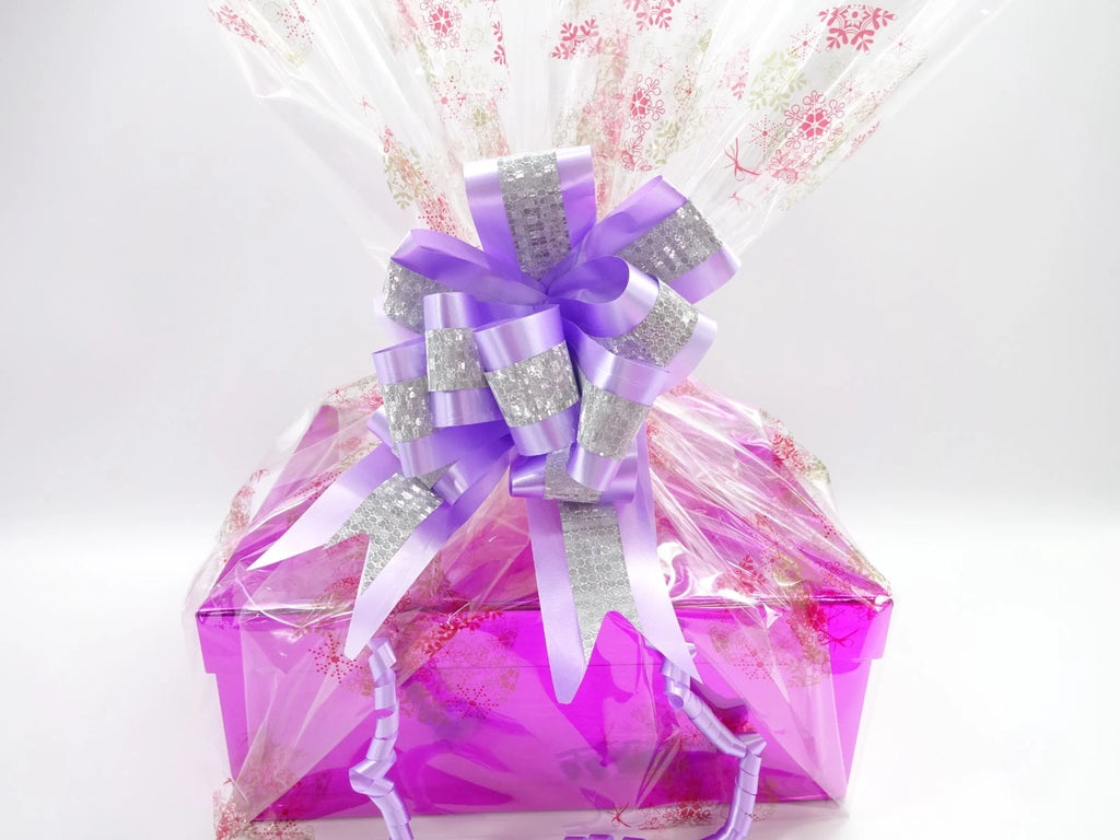 Festively wrapped Christmas hamper with purple and silver ribbon for her