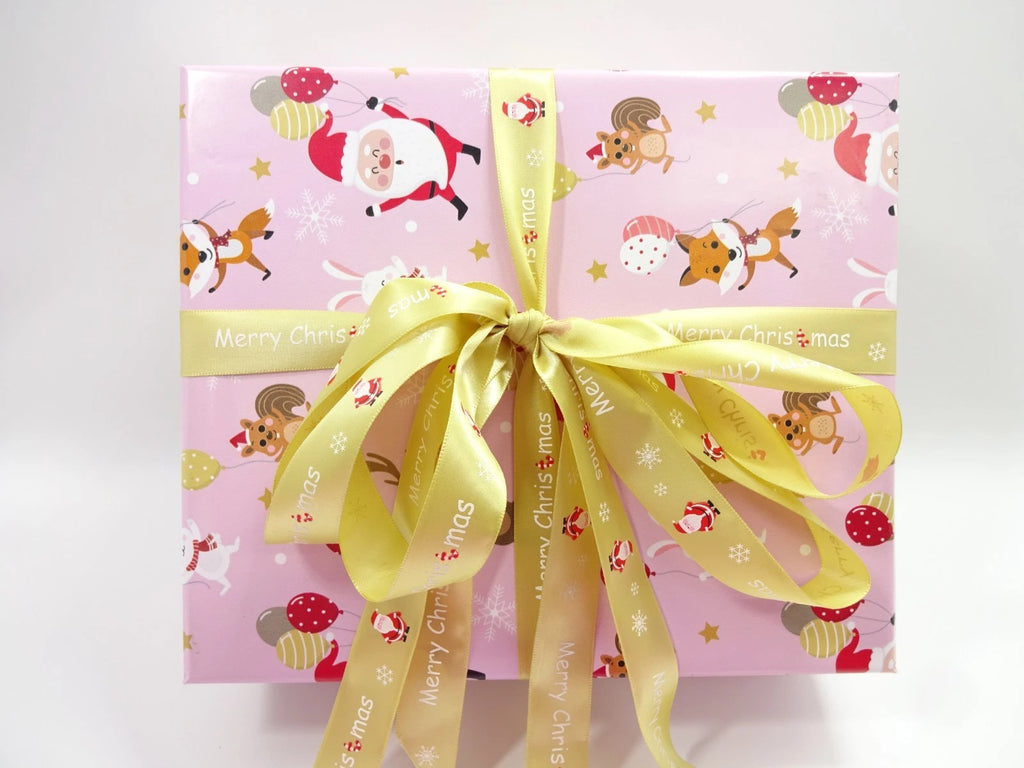 Gift box with festive design and yellow ribbon on a white background