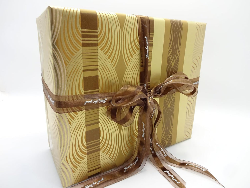 Father’s Day gift set wrapped in gold patterned paper with brown ribbon, angled front view