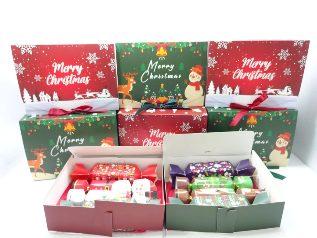 Set of Christmas-themed gift boxes with festive designs on a white background