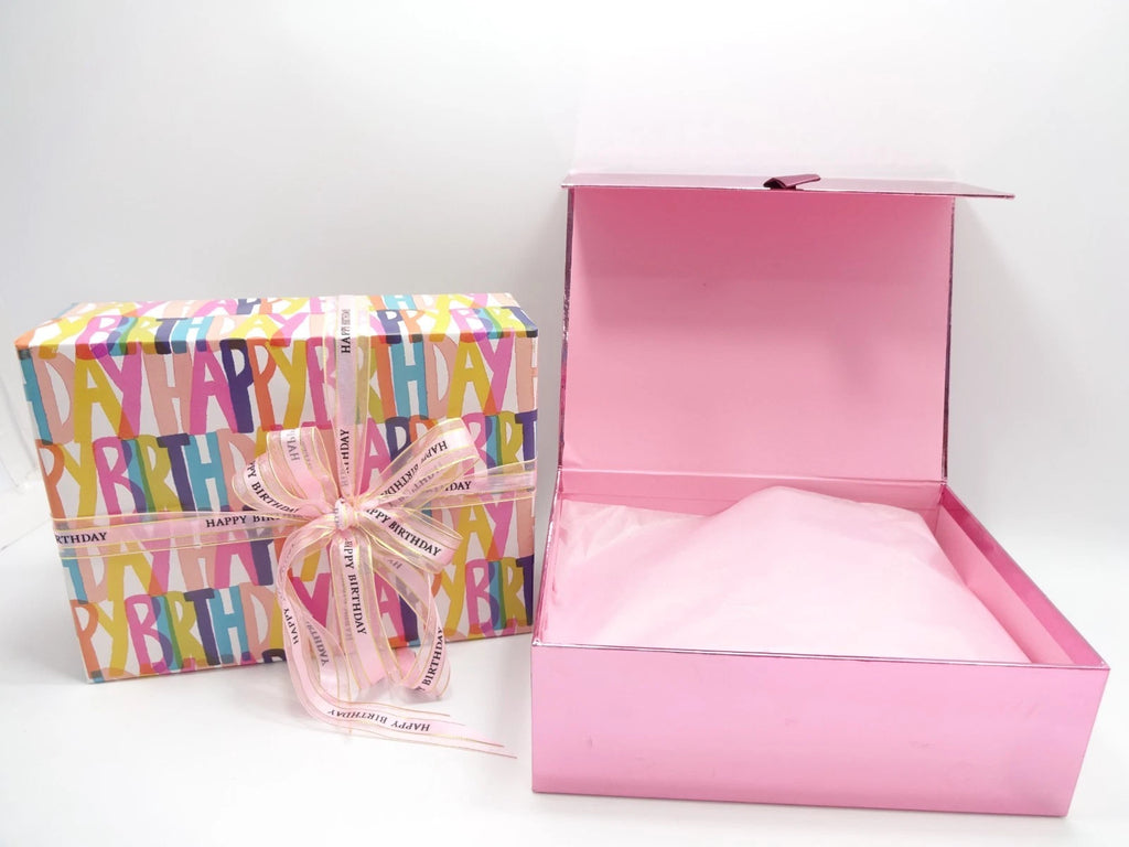 Happy Birthday gift box opened showing tissue-wrapped Maybelline makeup set