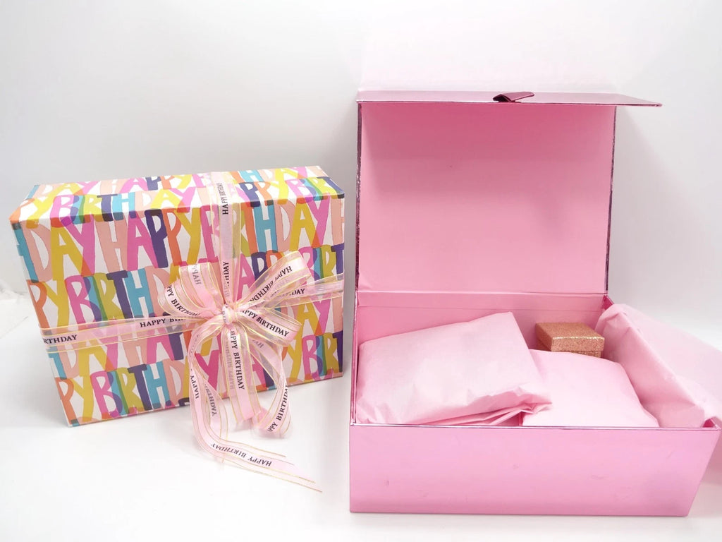Happy Birthday gift box opened showing tissue-wrapped Maybelline makeup set