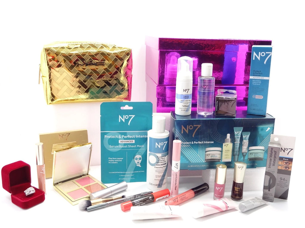 Close-up of No7 beauty collection with luxury skincare, makeup, and golden makeup bag beside pink and white Christmas boxes.