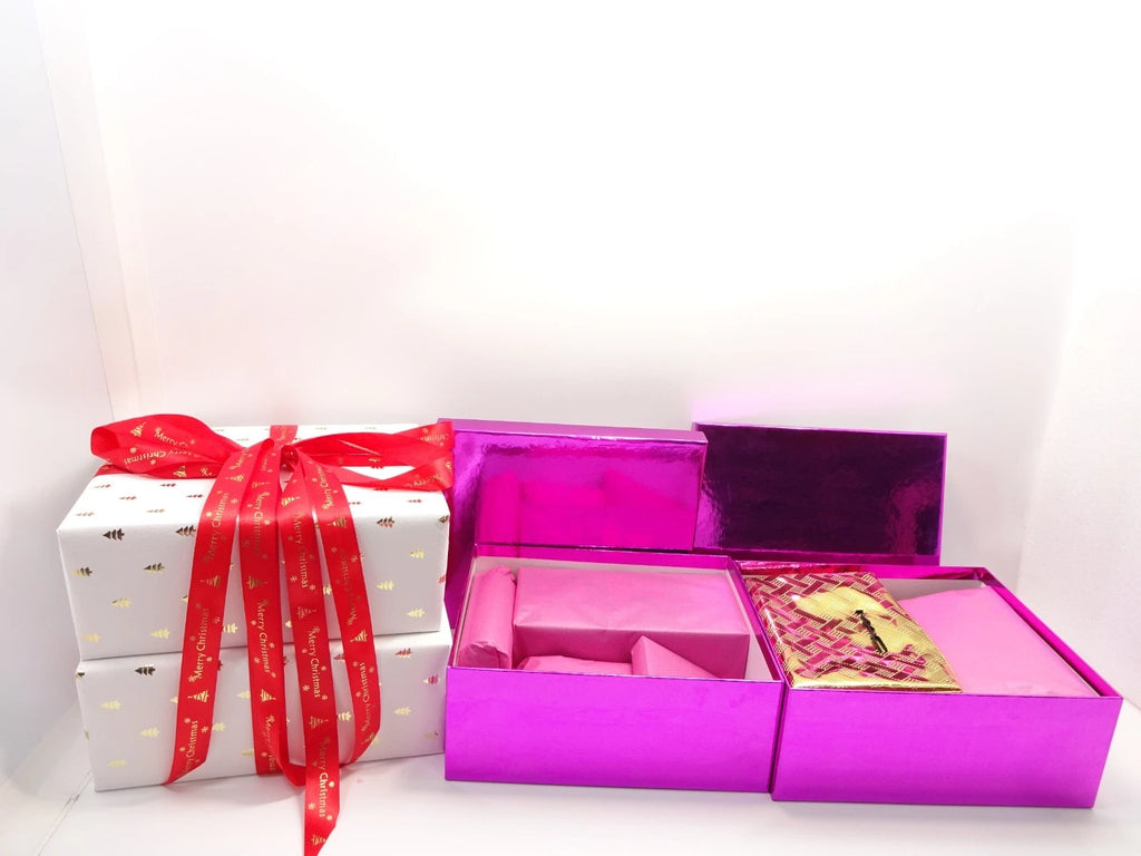 Open view of No7 Christmas set in metallic pink boxes, lined with pink tissue wrapping for elegant presentation.