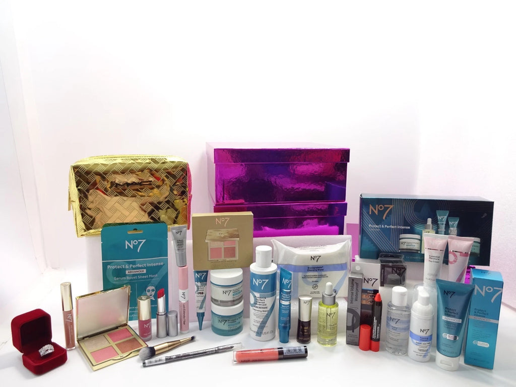No7 Protect & Perfect skincare range, beauty products, and accessories arranged with gold MAC bag and purple boxes.