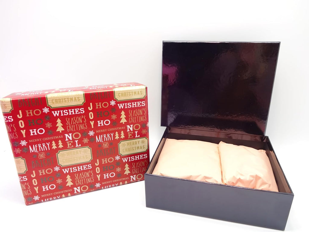 Festive red gift box with seasonal designs, open to reveal makeup products wrapped in tissue paper