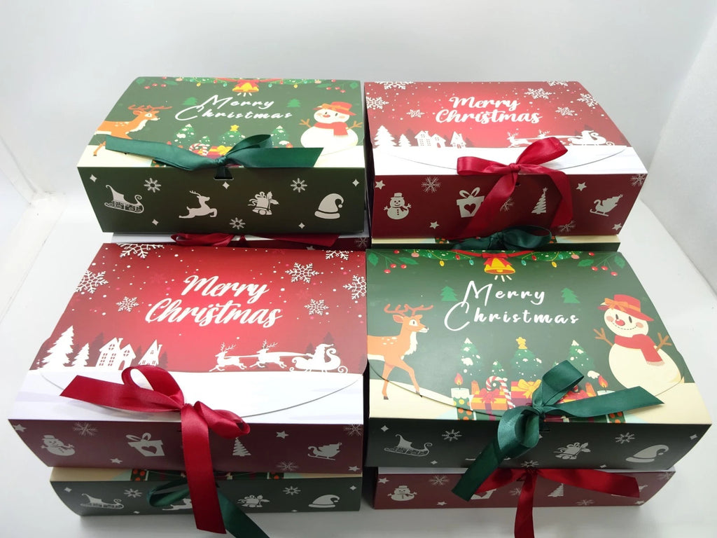 Red and green Merry Christmas themed gift boxes stacked with festive ribbons