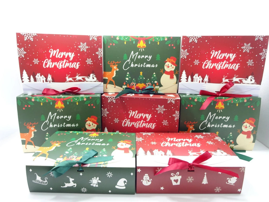 Close-up of green and red Merry Christmas boxes tied with green and red satin bows