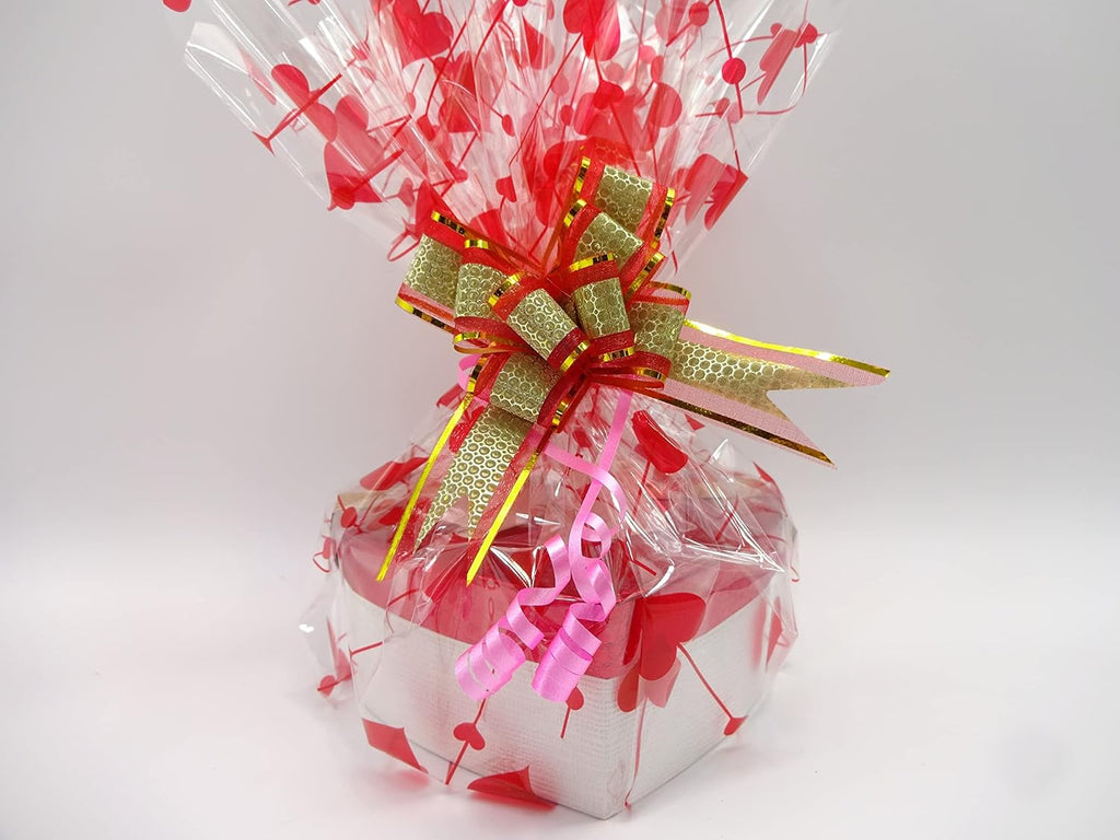 Gift hamper for her in red heart-shaped box with gold and white ribbon wrapping