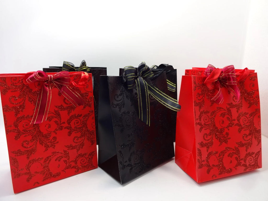 Halloween mystery bags with red and black tissue-wrapped cosmetic and jewellery gifts arranged in front