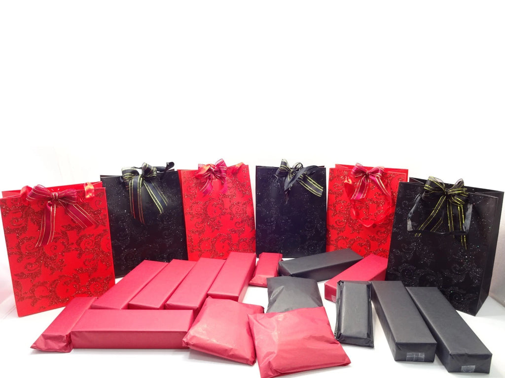 Close-up of red and black glittered Halloween mystery bags with striped ribbon bows