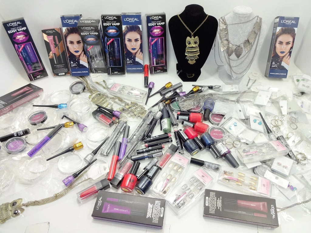 Flatlay of multiple mystery bags and wrapped cosmetic gifts ready for Halloween gifting