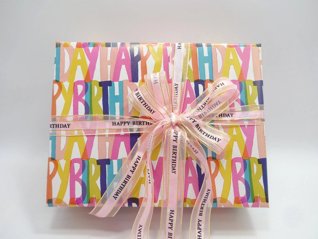 Top view of closed Happy Birthday makeup gift box with ribbon tied