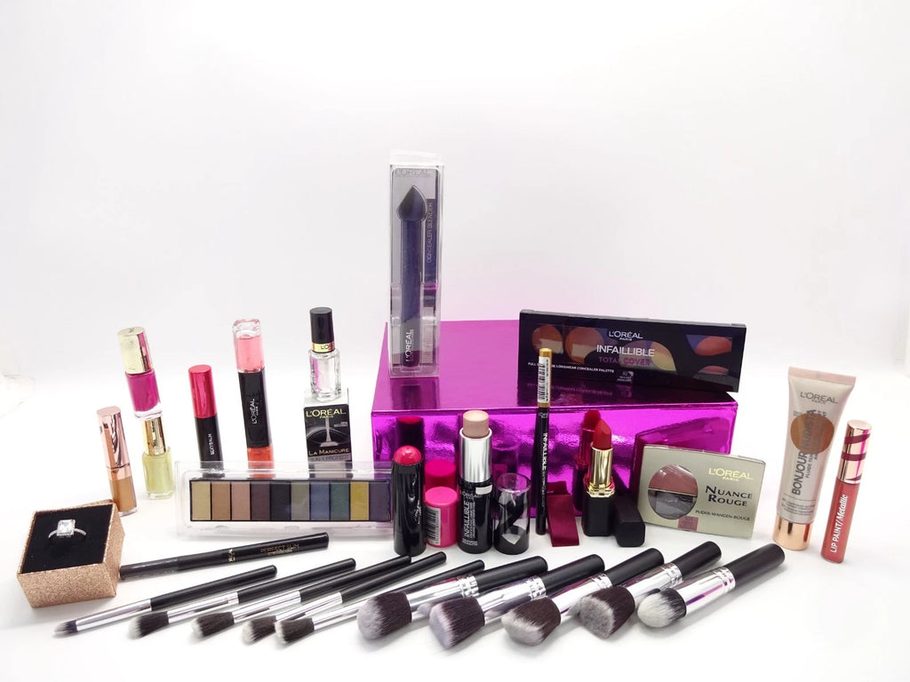 Assorted L’Oreal makeup products including brushes, lipstick, eyeshadow palette, and foundation displayed neatly