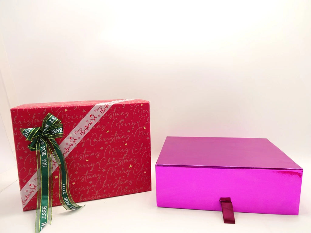 Pink and red L’Oreal gift boxes closed and neatly wrapped with ribbons
