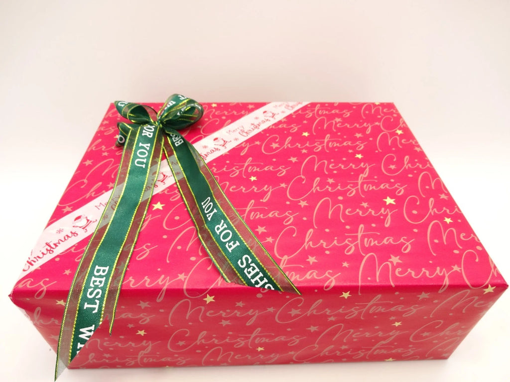 Top view of L’Oreal Christmas makeup gift box wrapped with green and white ribbon and bow