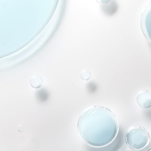 Close-up of Lancôme Bi-Facil Eye Makeup Remover texture with blue cleansing droplets