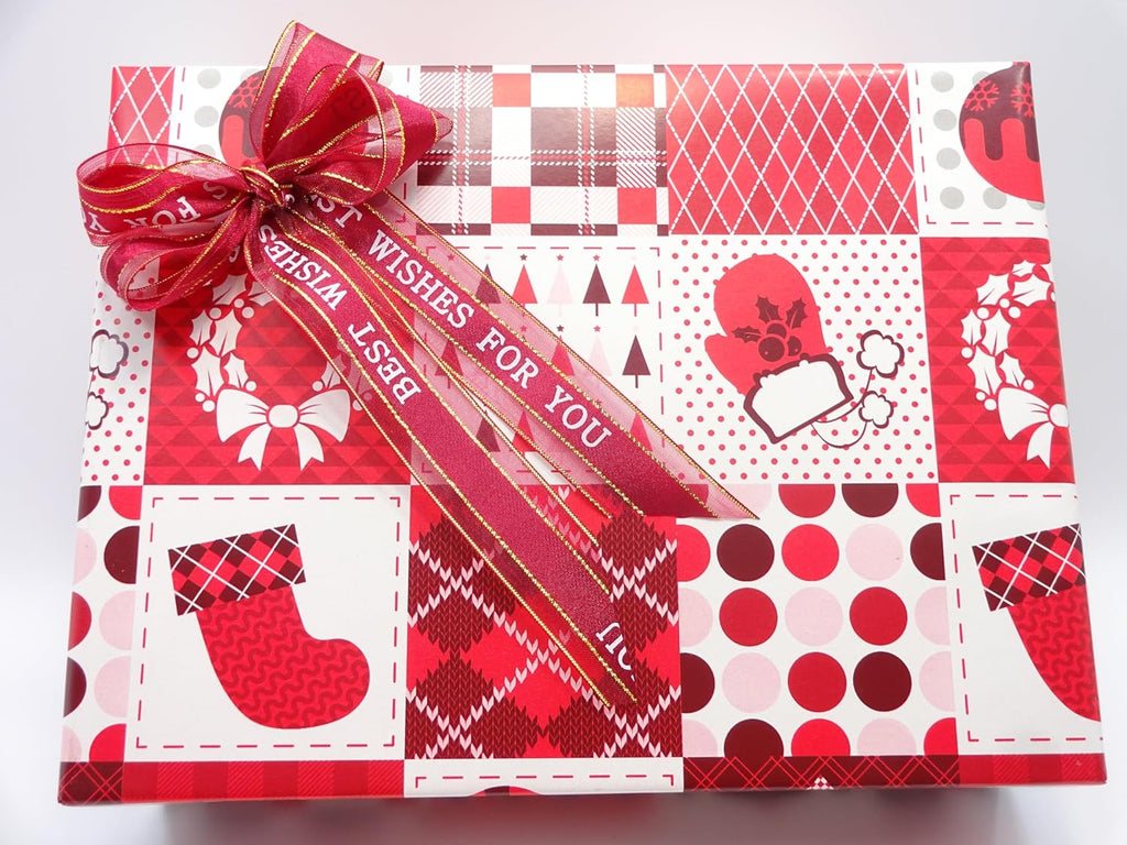 Festive L'Oréal Christmas Glam Gift Set Box with red and white wrapping paper, topped with a red ribbon and bow.