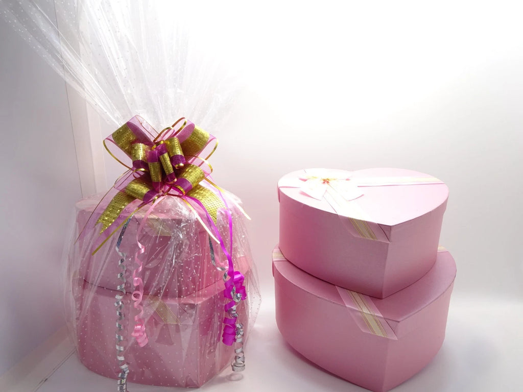Stacked heart-shaped pink boxes with ribbon bows, part of L’Oréal makeup gift set