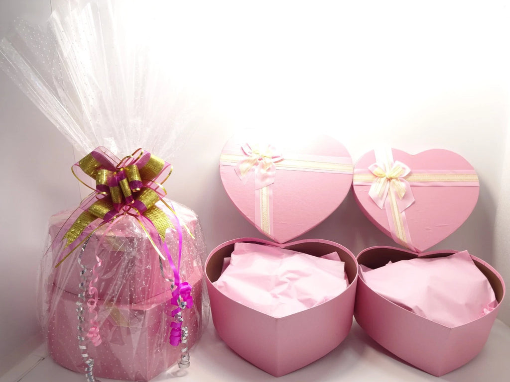 Open pink heart boxes showing tissue wrapping and beauty gift presentation inside