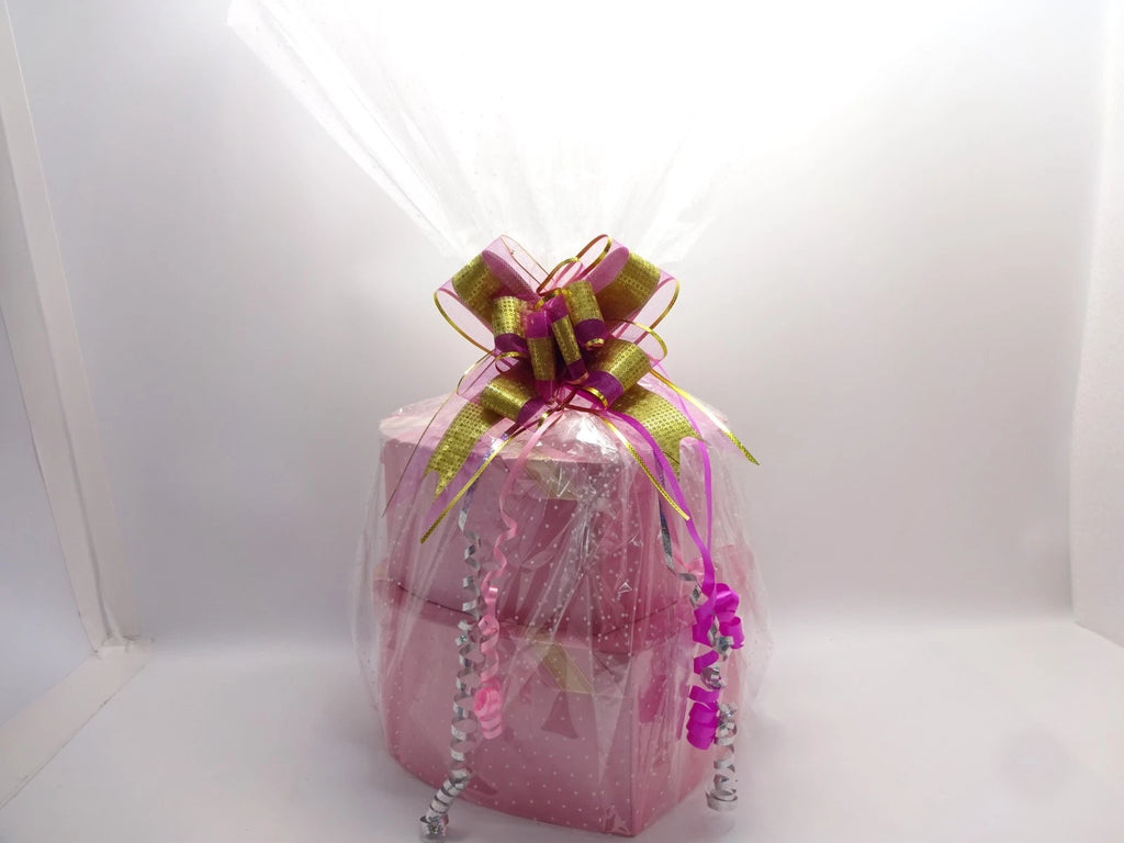 L’Oréal 2-tier makeup gift hamper wrapped in pink polka-dot cellophane with gold and purple bow