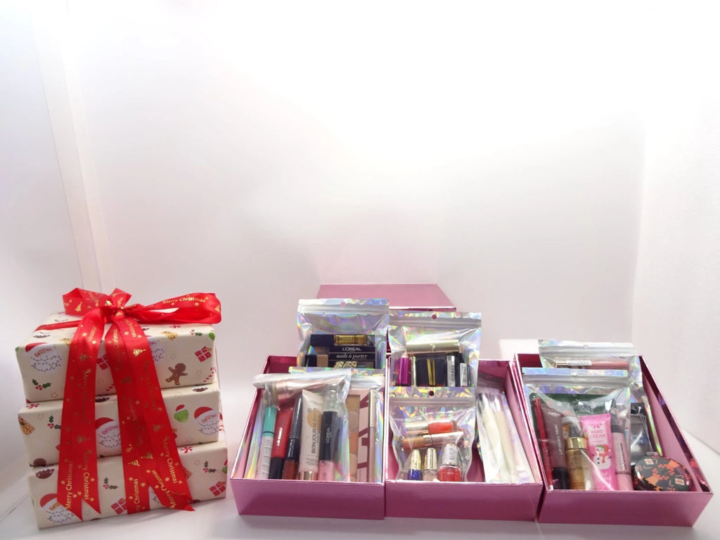 Opened pink beauty boxes showing holographic pouches filled with beauty products