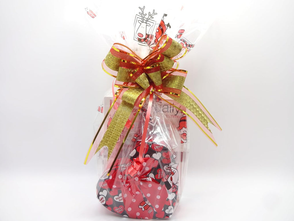 Love Actually gift hamper wrapped in festive red and gold wrapping with a heart-shaped box, perfume, and makeup inside.