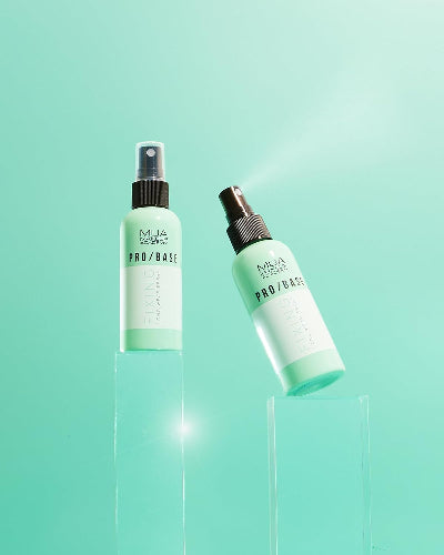 Flatlay of MUA Pro/Base Fixing Spray 70ml on pastel green background