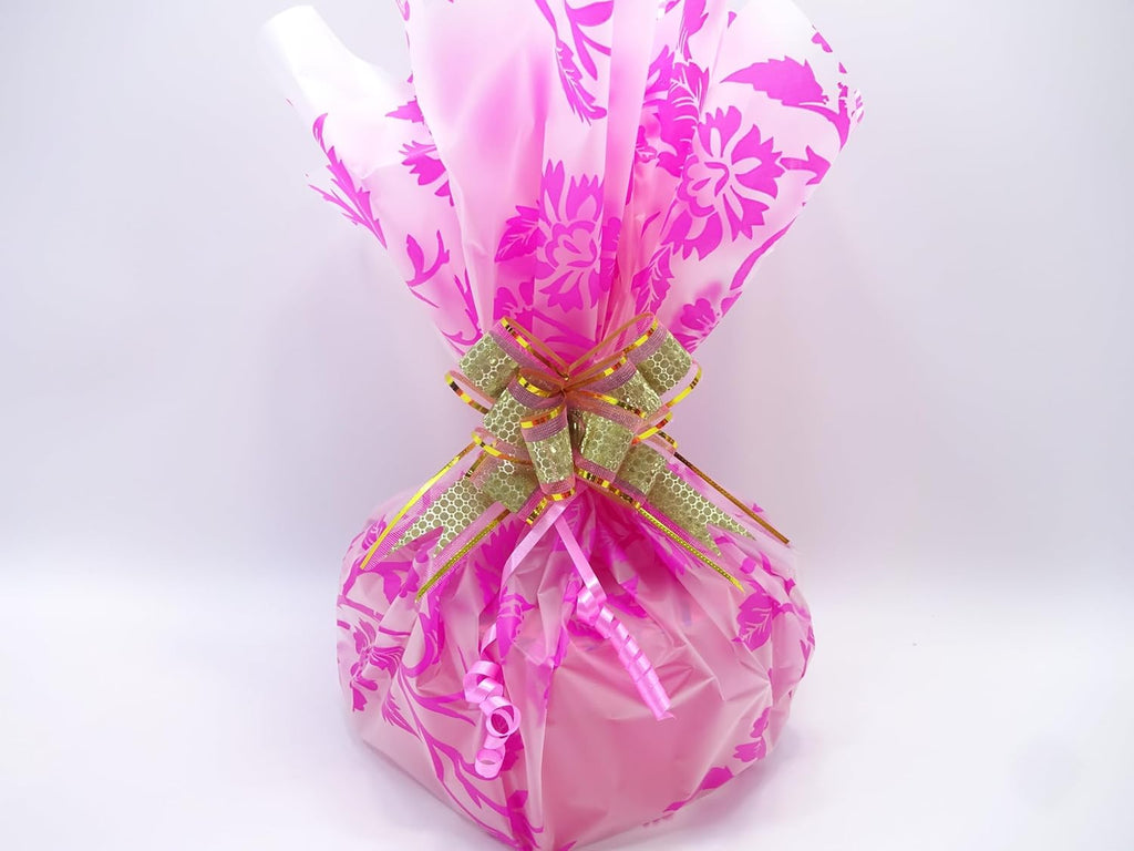 Detailed view of the pink floral wrapping and decorative gold and pink bow, adding a touch of elegance to the gift hamper