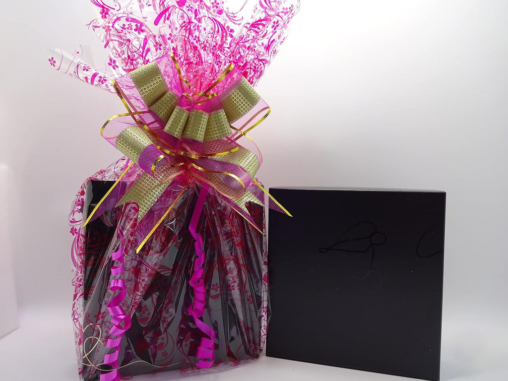 Elegant black gift box and floral-themed pink and gold gift wrap