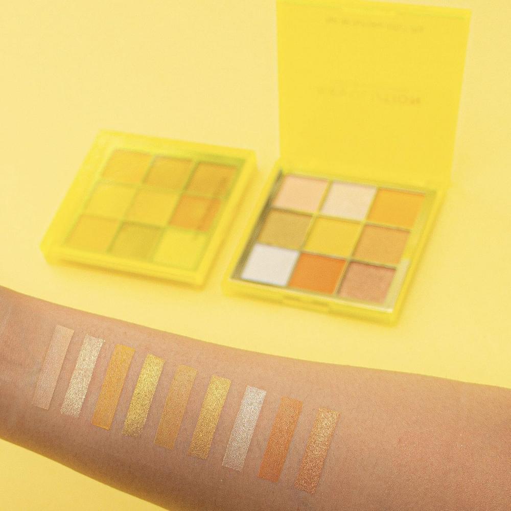 Makeup Revolution Neo Eyeshadow Palette swatches on light skin, displaying vibrant yellow and orange hues.