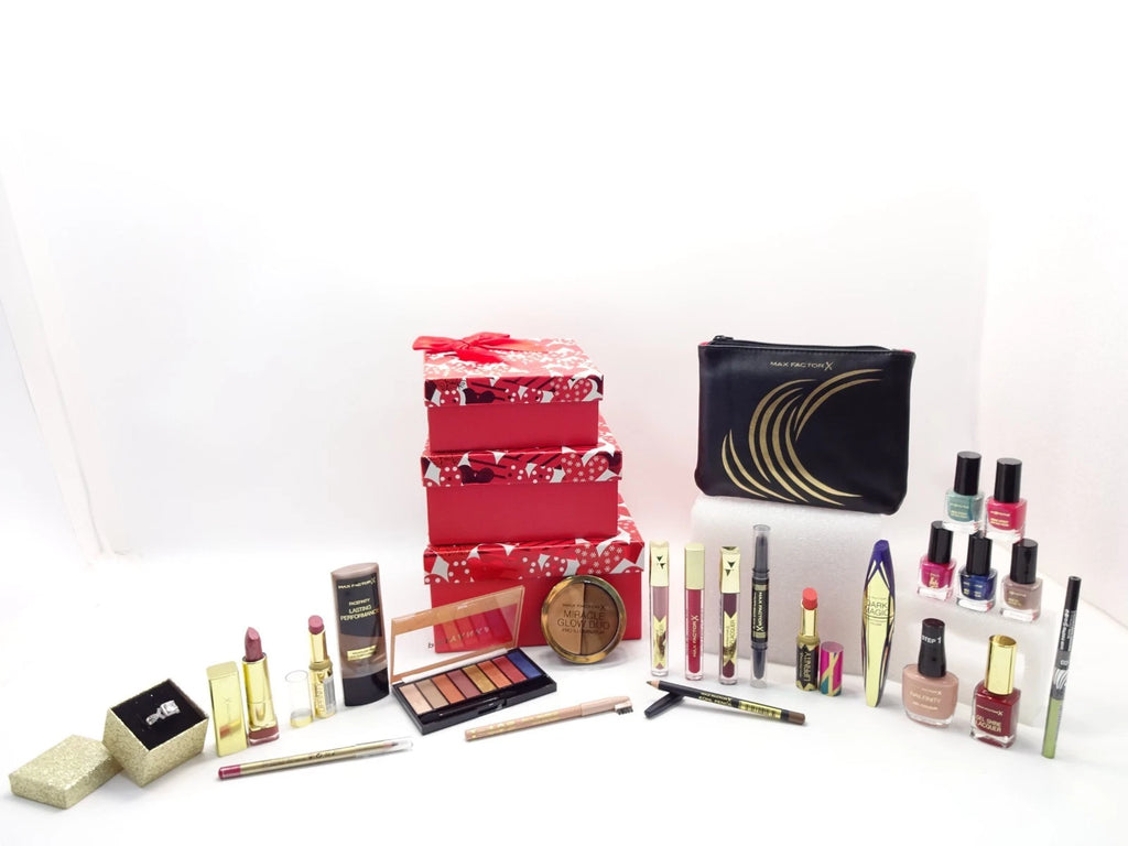 Beautifully wrapped Max Factor beauty gift hamper in clear red polka-dot cellophane with metallic red bow