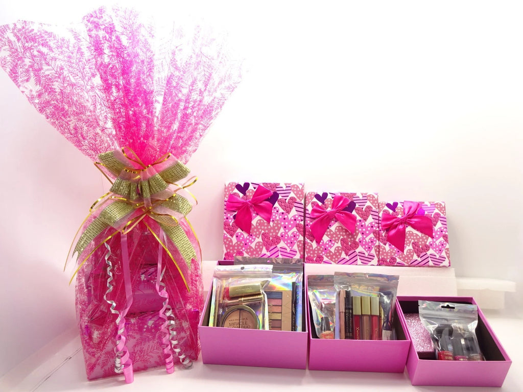 Complete Max Factor 3-tier gift hamper with beauty items, nail polishes, brushes, and pink boxes