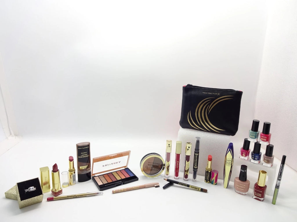 Open red boxes with neatly arranged Max Factor cosmetics, brushes, and accessories