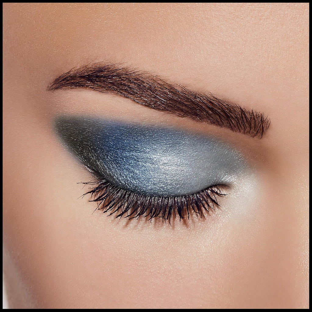 Close-up of closed eye showcasing the smooth blend of silver and blue shimmer from Max Factor Azure Allure palette