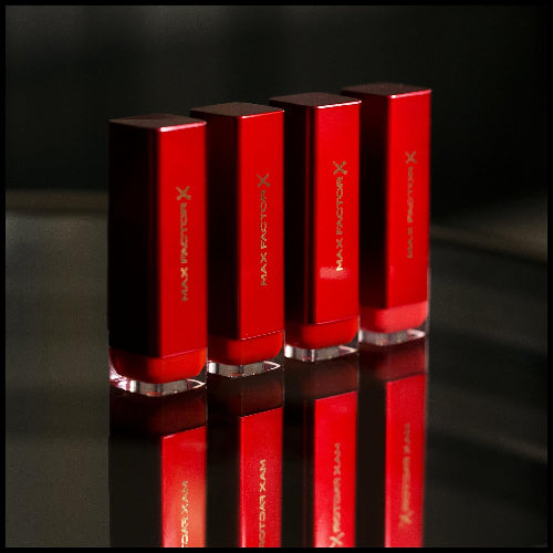 Row of Max Factor Colour Elixir Ruby Red lipsticks in striking reflective red packaging
