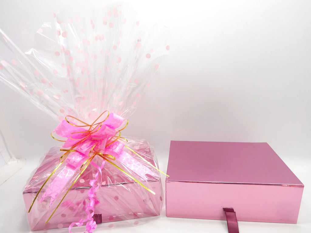 Maybelline pink luxury gift box wrapped in cellophane with polka dot design and large pink bow