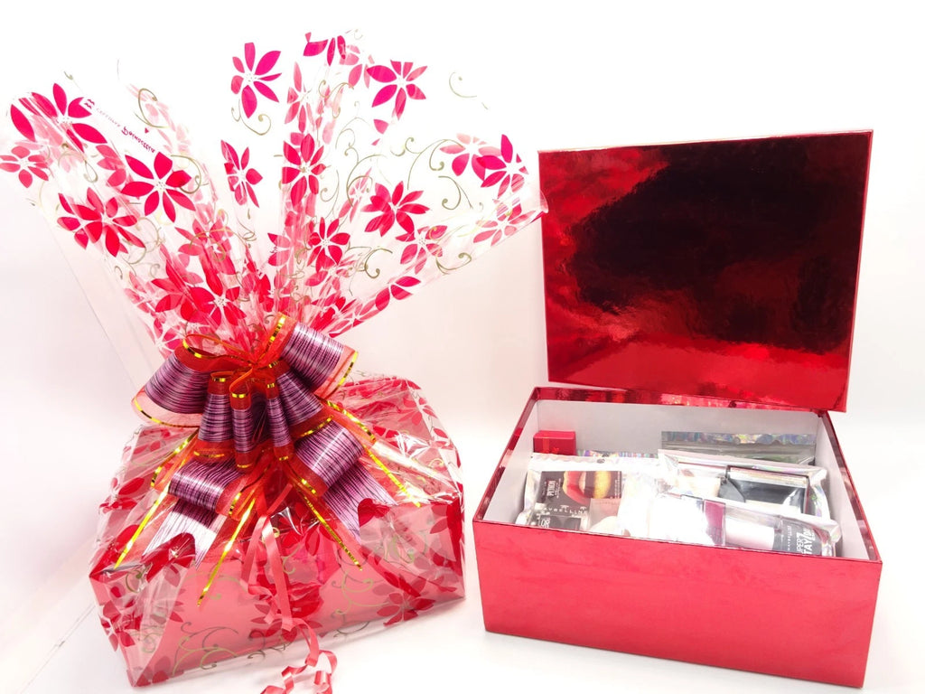 Side view of Maybelline 26pc Makeup Gift Hamper open red box with tissue wrapping